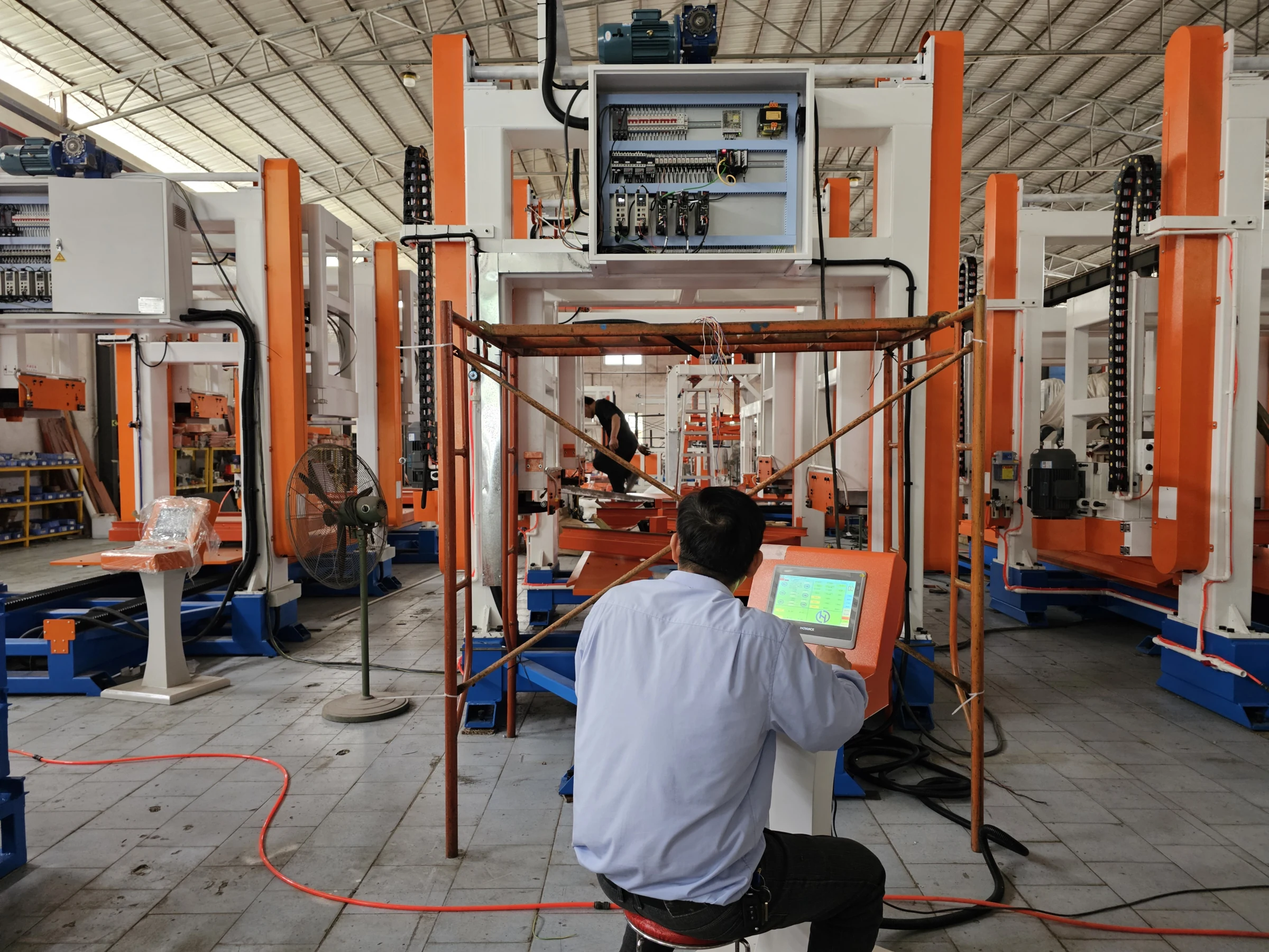HENGDE technician working at the equipment control panel during factory checks