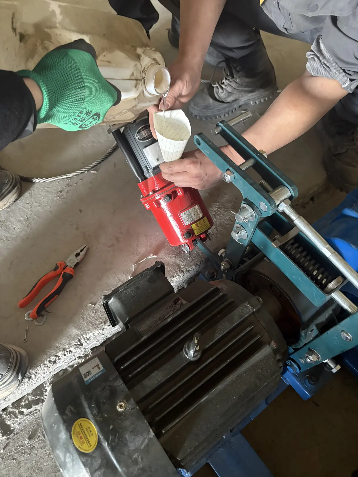 Installation team aligning production line rails and drive equipment