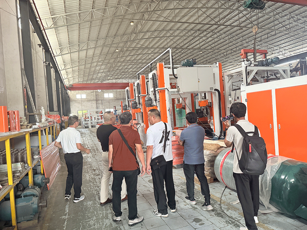 Cambodia project team reviewing HENGDE lightweight block production equipment — factory visit image 1