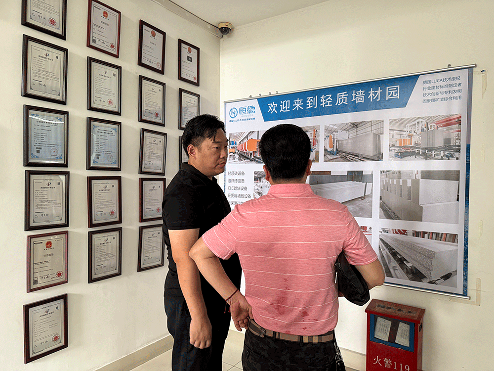 China project team reviewing HENGDE ceramsite wall panel production equipment — factory visit image 2