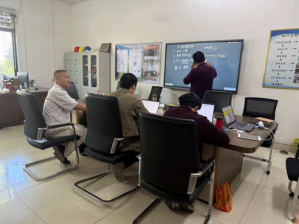 HENGDE project team reviewing HENGDE solid-waste lightweight materials production equipment — factory visit image 1