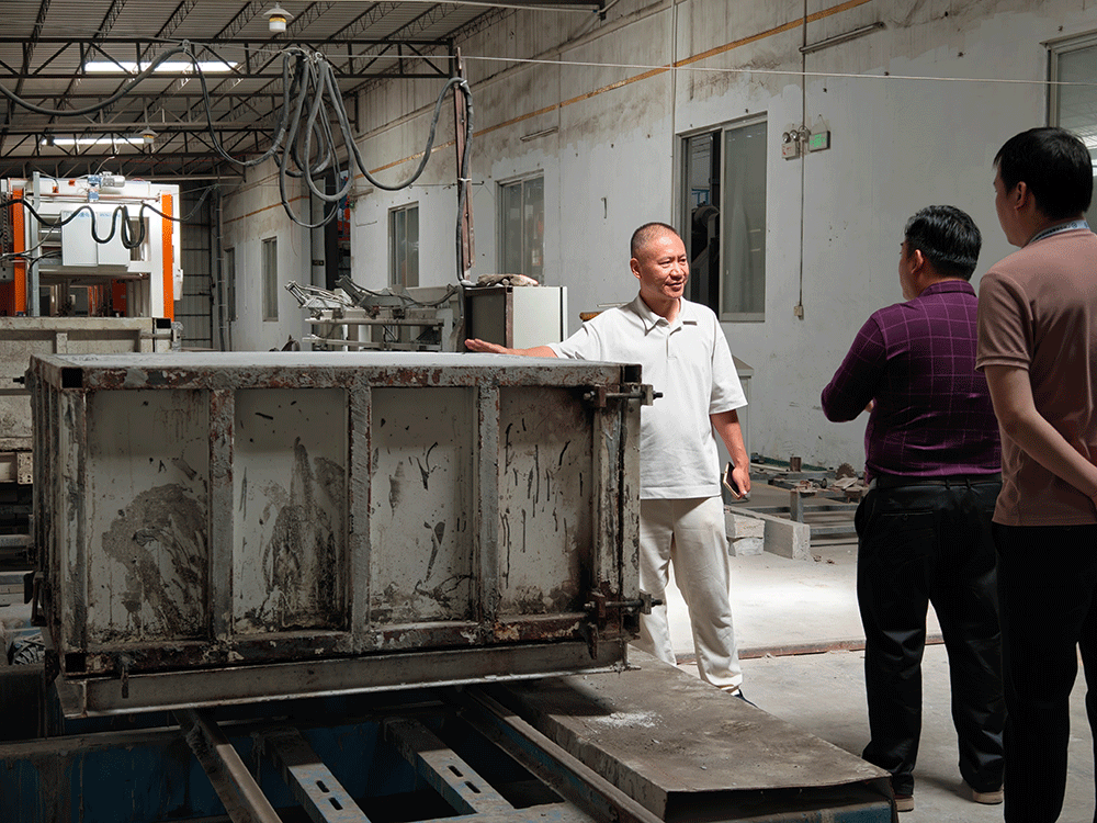HENGDE project team reviewing HENGDE solid-waste lightweight materials production equipment — factory visit image 2