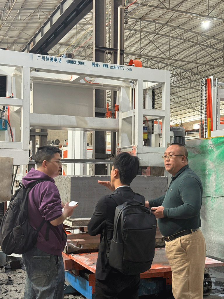 China project team reviewing HENGDE cutting system production equipment — factory visit image 1