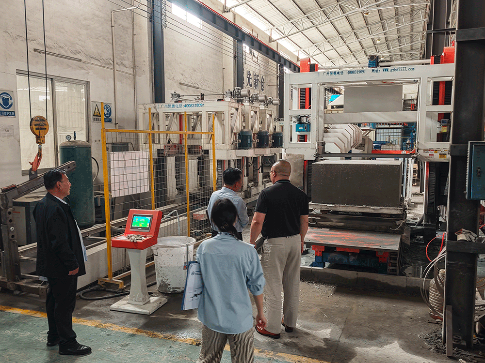China project team reviewing HENGDE self-insulating block production equipment — factory visit image 1