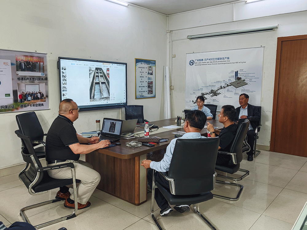China project team reviewing HENGDE self-insulating block production equipment — factory visit image 2