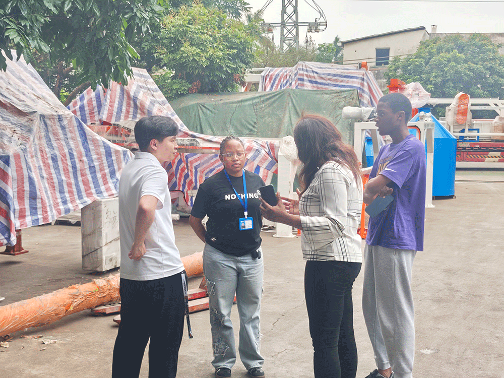 South Africa project team reviewing HENGDE lightweight wall panel production equipment — factory visit image 3