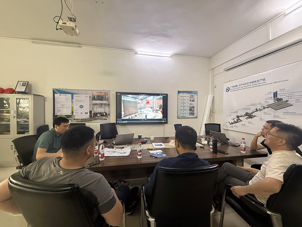 Kyrgyzstan project team reviewing HENGDE lightweight wall panel production equipment — factory visit image 1