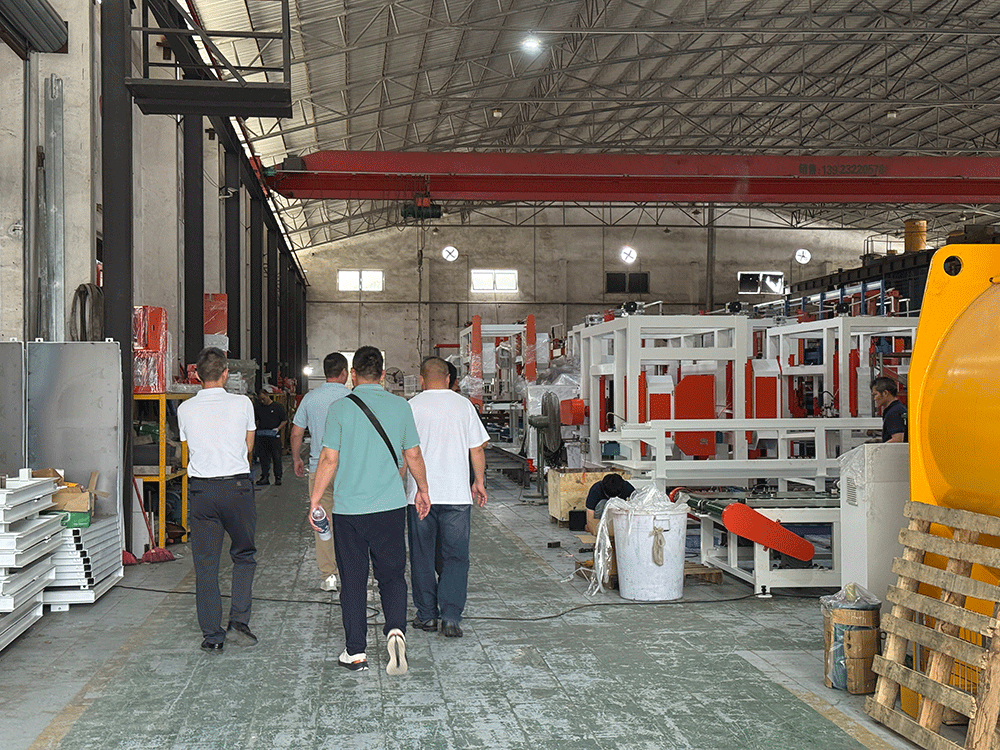 Mongolia project team reviewing HENGDE self-insulating block production equipment — factory visit image 1