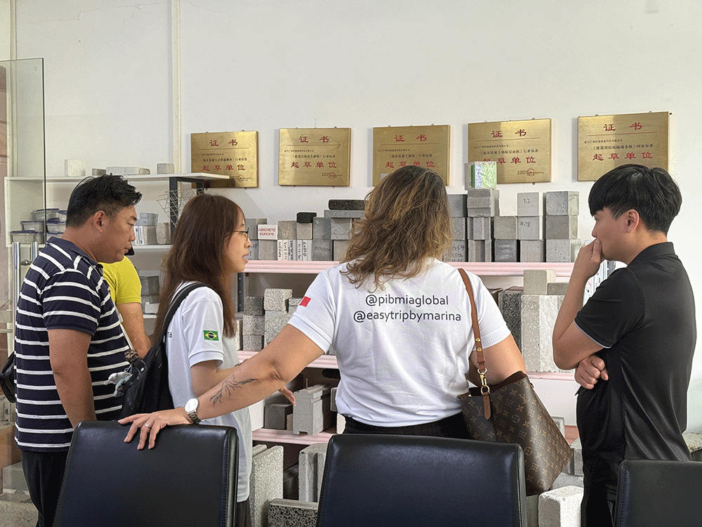 Brazil project team reviewing HENGDE lightweight wall panel production equipment — factory visit image 2