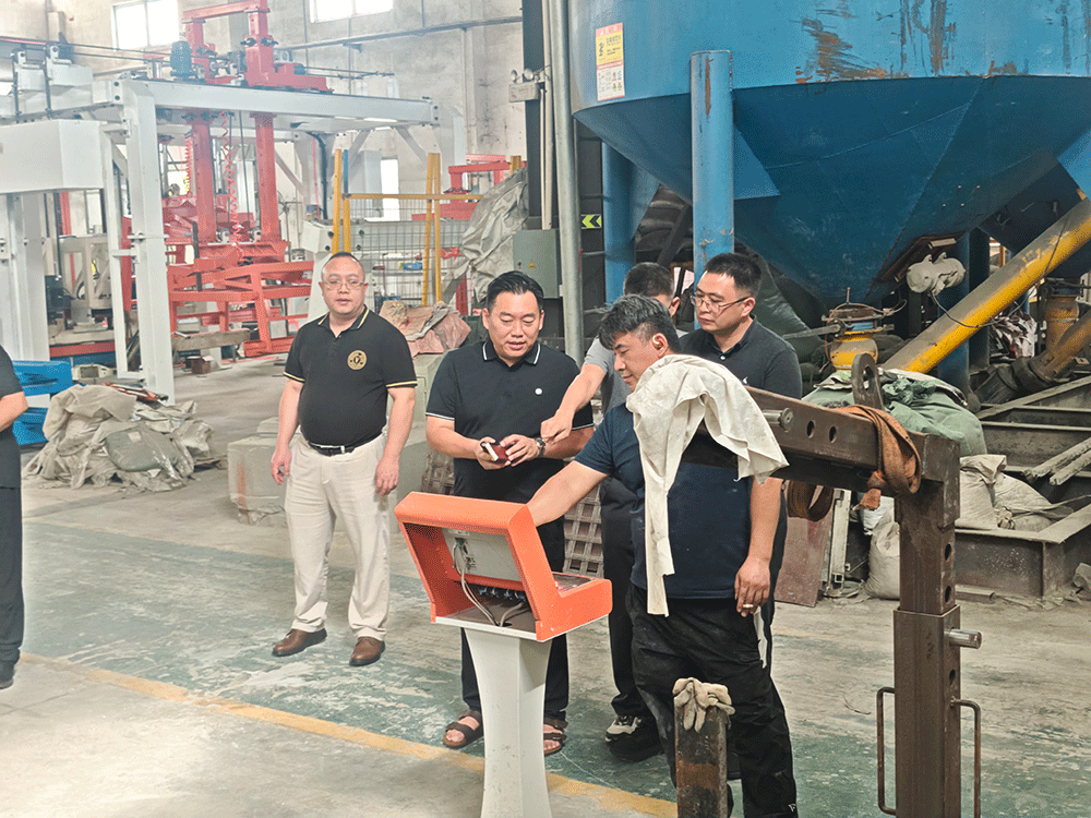 China project team reviewing HENGDE self-insulating block production equipment — factory visit image 2