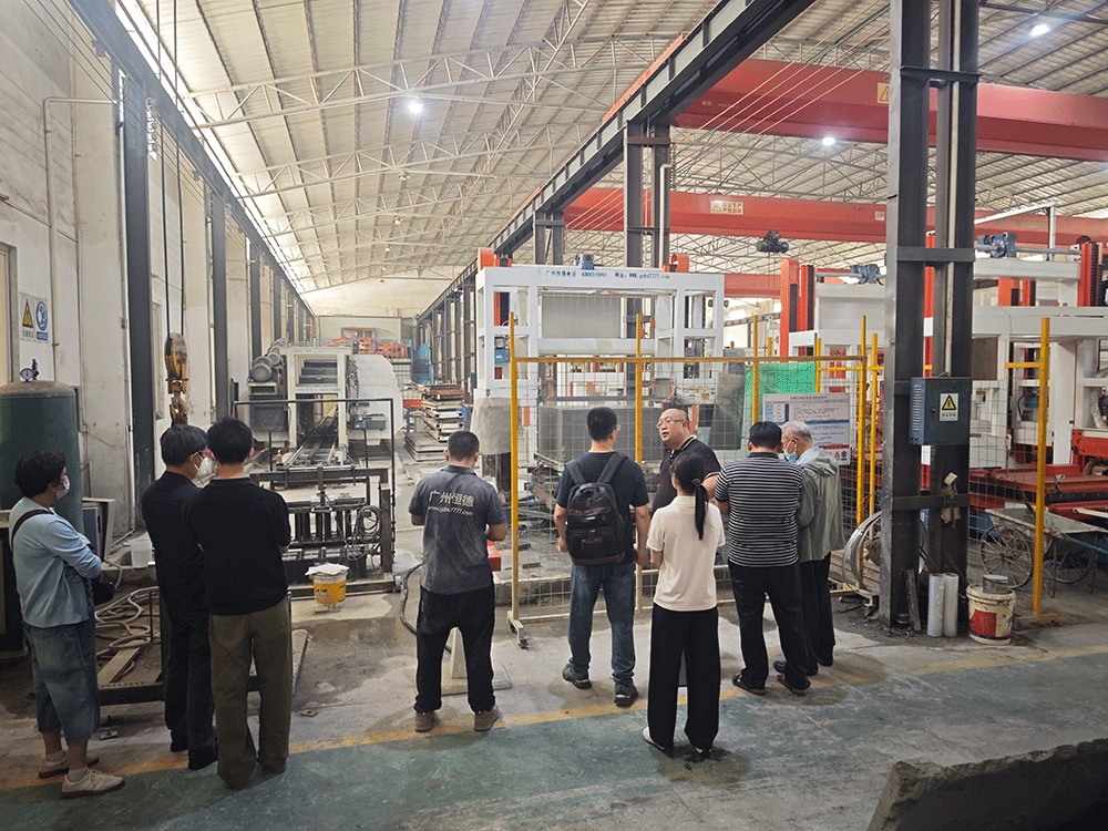 Malaysia project team reviewing HENGDE lightweight wall panel production equipment — factory visit image 1