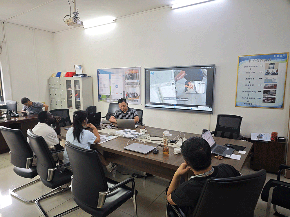 Ghana project team reviewing HENGDE lightweight block production equipment — factory visit image 1