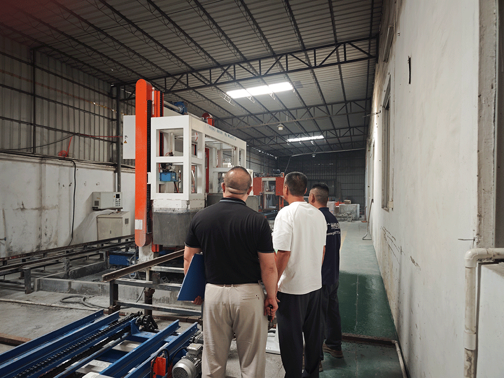 China project team reviewing HENGDE fire-door core panel production equipment — factory visit image 1