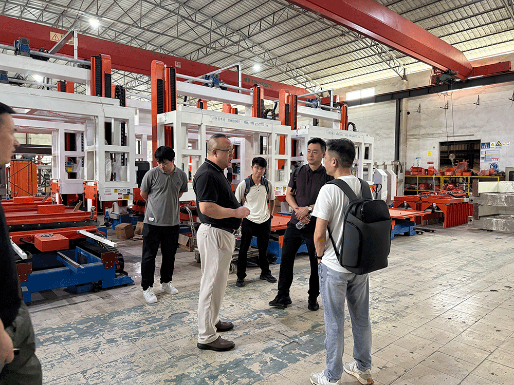 China project team reviewing HENGDE solid-waste lightweight materials production equipment — factory visit image 1