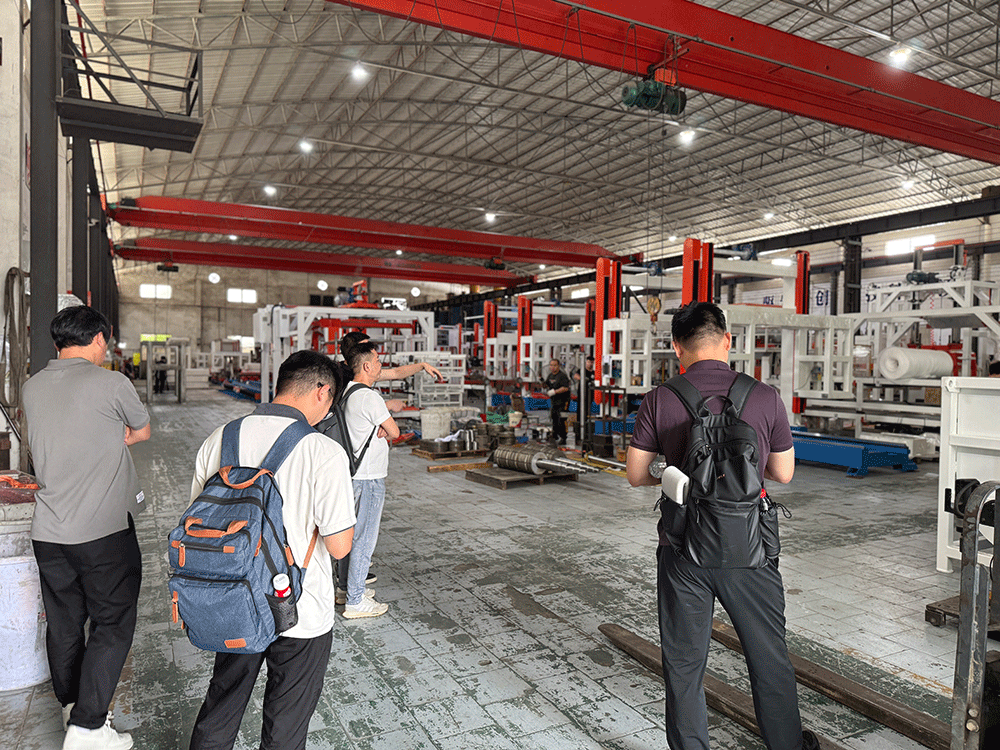 China project team reviewing HENGDE solid-waste lightweight materials production equipment — factory visit image 2