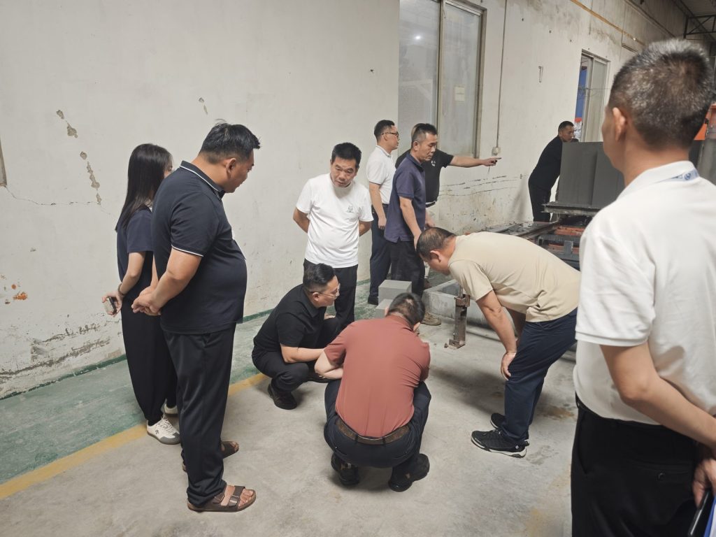 Project team reviewing connected cutting and material handling equipment at Hengde factory