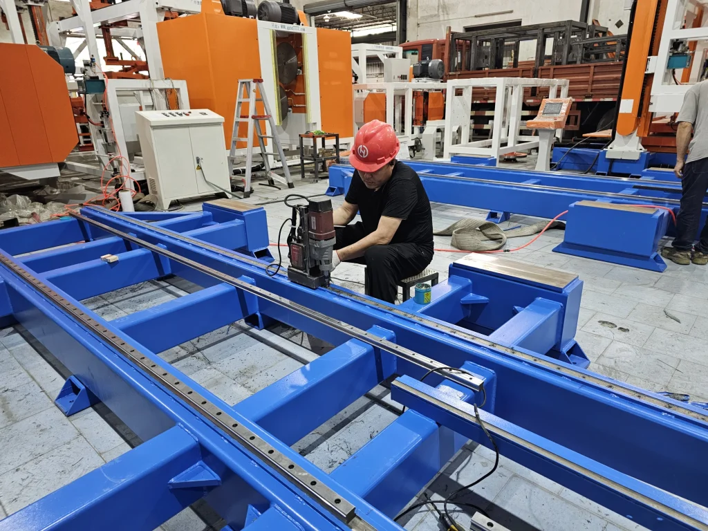 HENGDE technician machining a production-equipment frame in the Foshan workshop