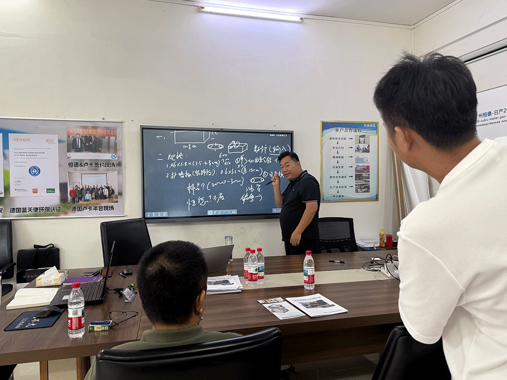China project team reviewing HENGDE fire-door core panel production equipment