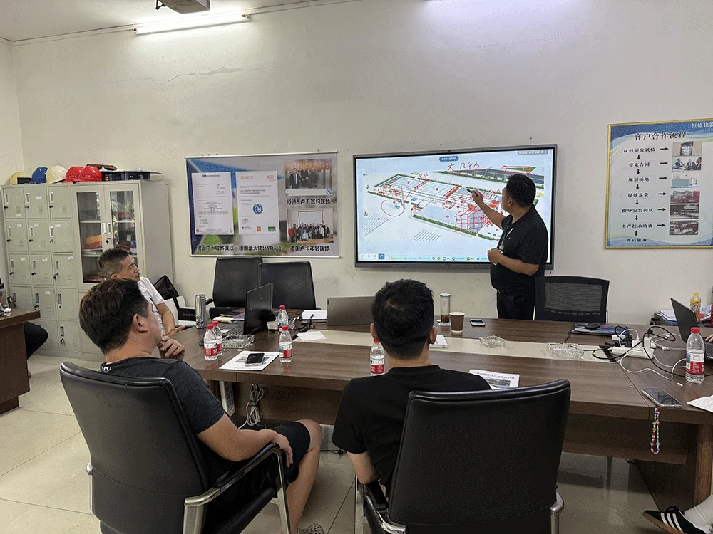 Indonesian customer reviewing a lightweight block production-line layout with the HENGDE team